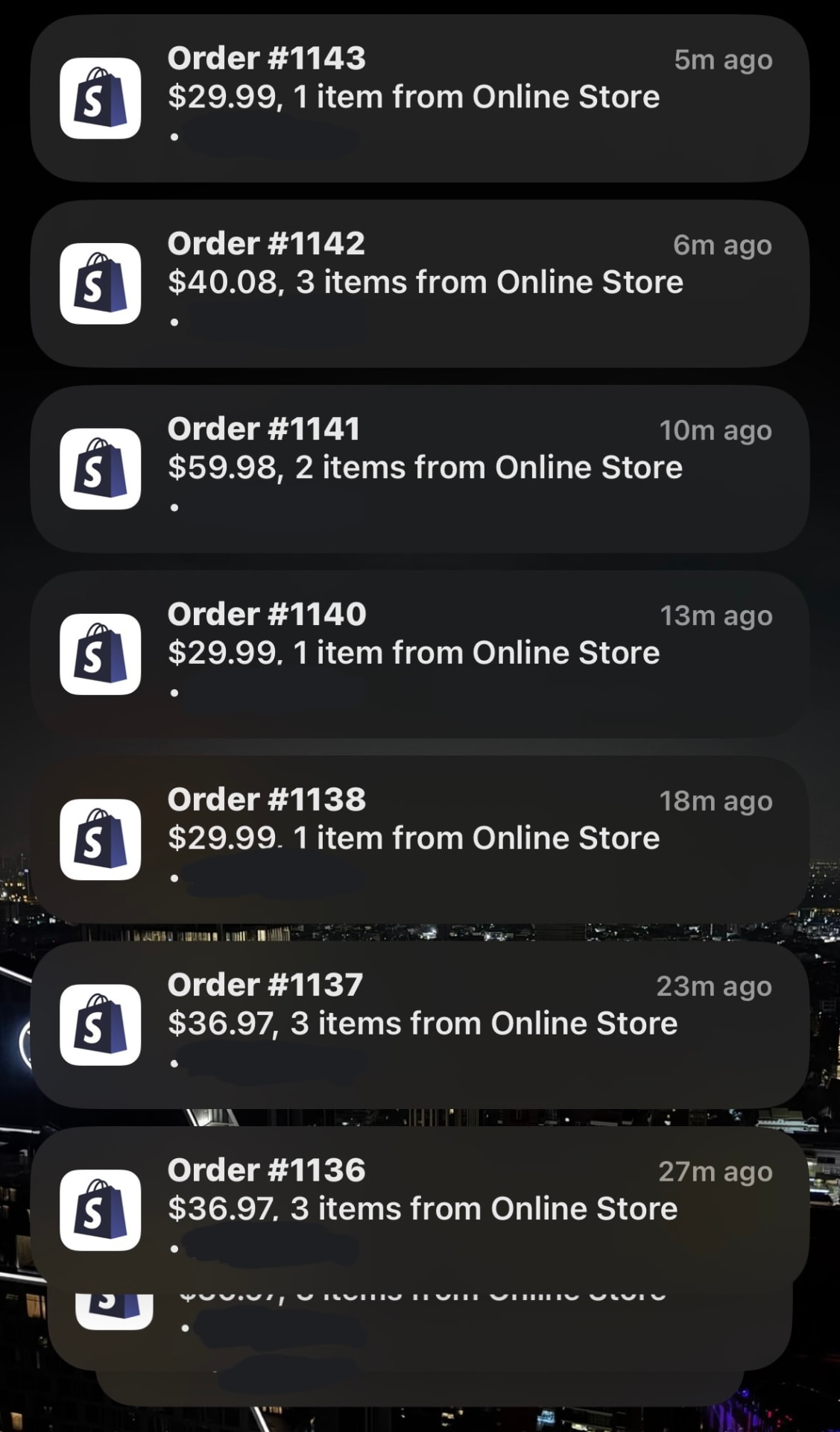 Phone lock screen filled with Shopify order notifications, orders #1136 to #1143 arriving within half an hour.
